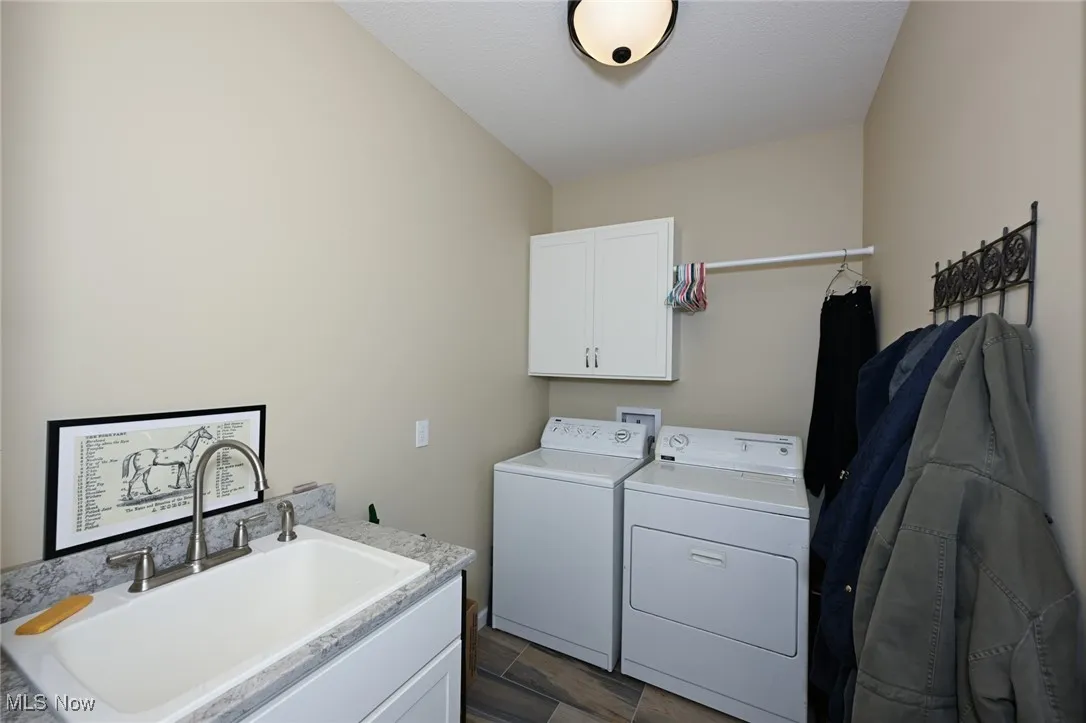 Laundry room with cabinet space and washer and clothes dryer