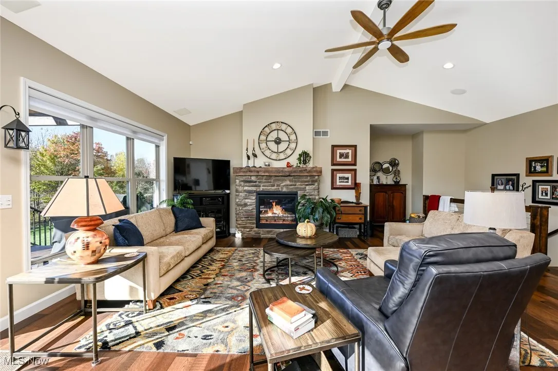 Living room with a fireplace, wood finished floors, and recessed lighting