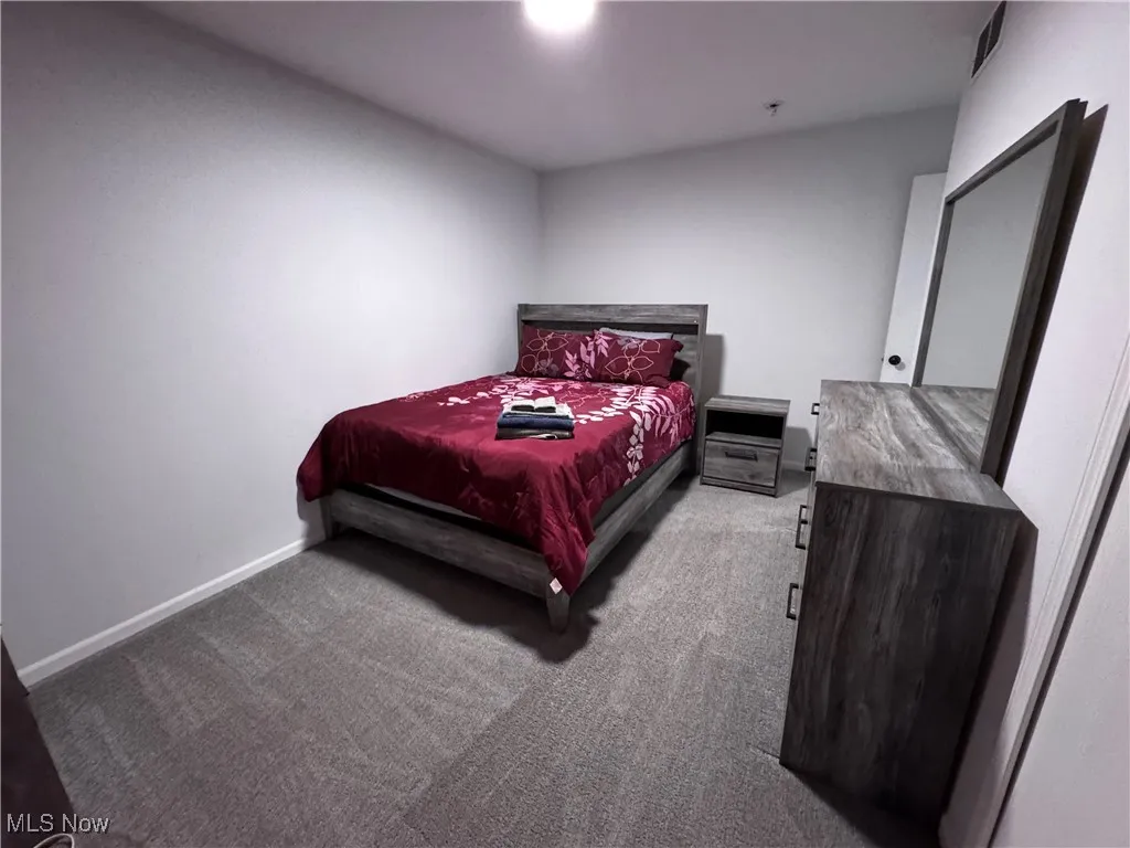 Carpeted bedroom with baseboards