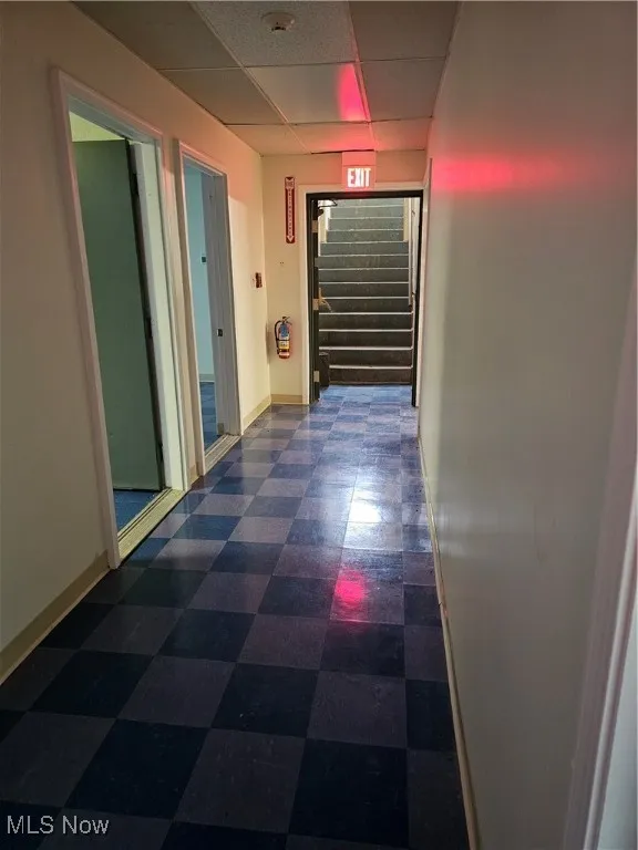 Basement classroom hallway and stairway that leads out to the rear fenced yard.