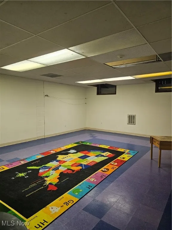 Game room with tile patterned floors and a drop ceiling
