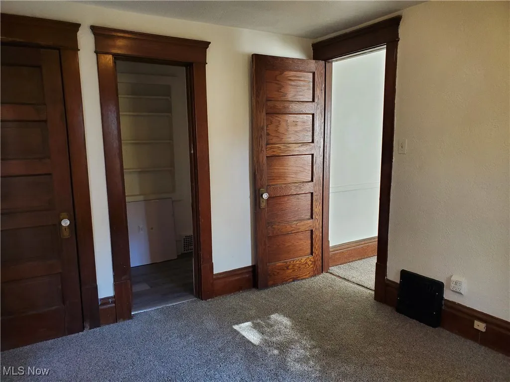 1st floor  bedroom featuring carpet flooring and baseboards