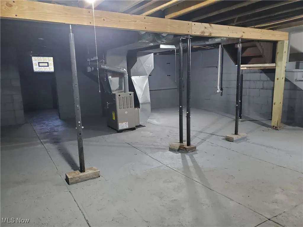 Below grade area featuring heating unit