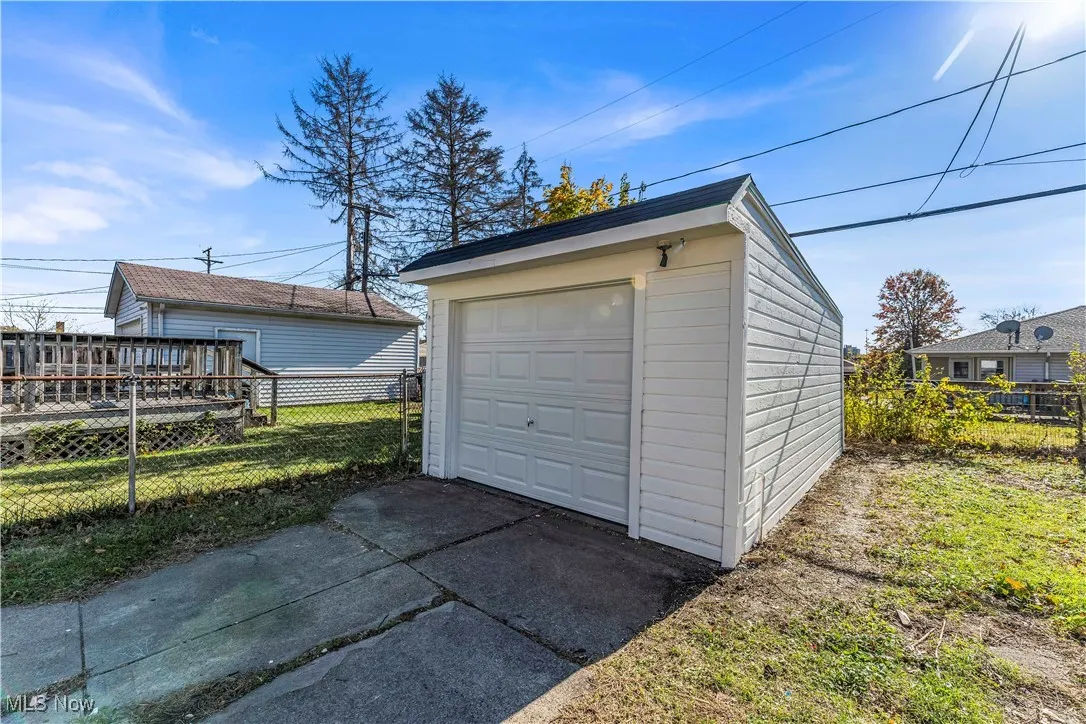 Detached garage featuring concrete driveway