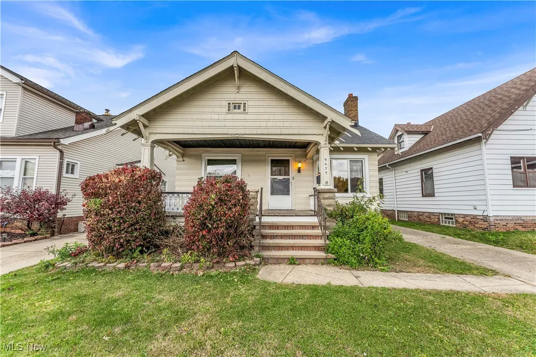 Shotgun-style home with covered porch, a front lawn, and a chimney
