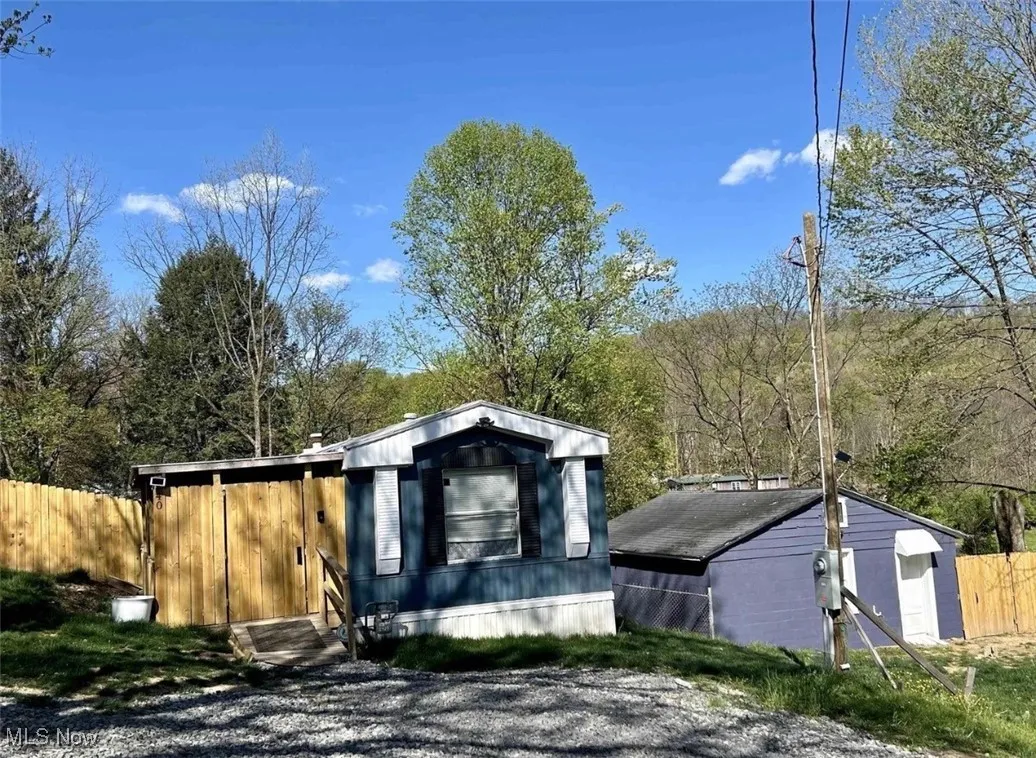 View of outdoor structure featuring a sunroom