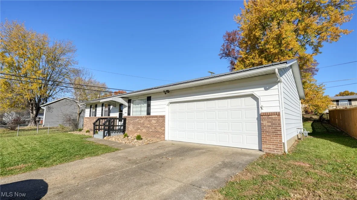 View of front of house with brick siding and a garage