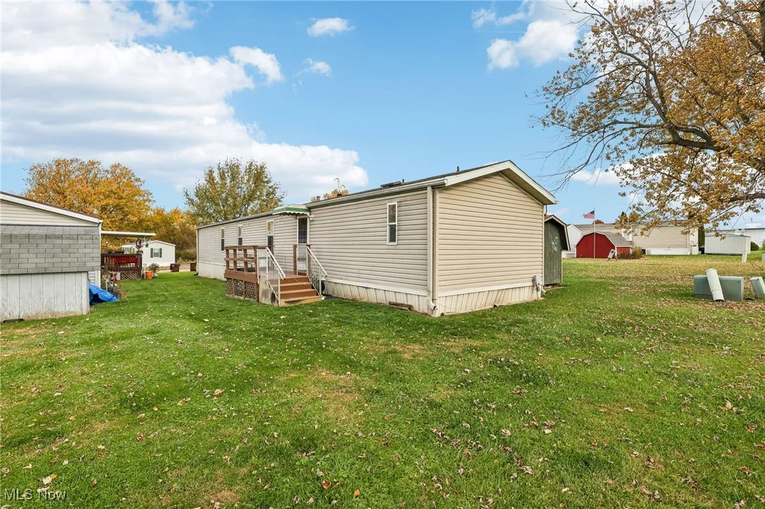 Rear view of property featuring a yard