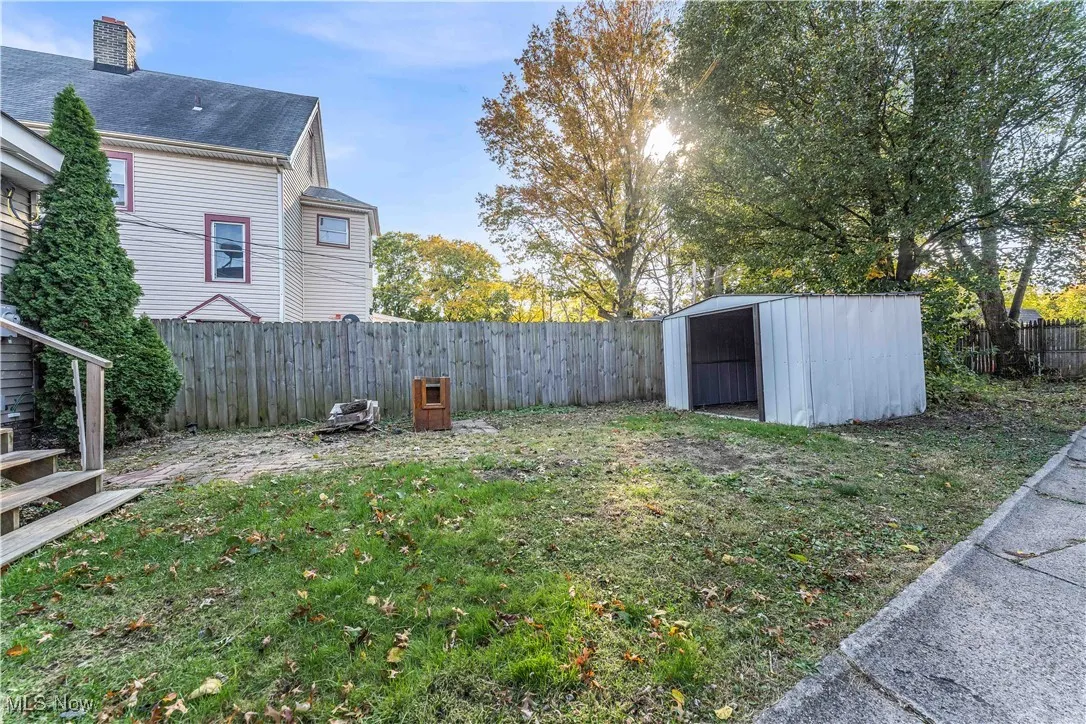 Fenced backyard with a storage shed