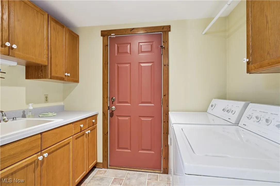 Laundry room with cabinet space and washing machine and clothes dryer