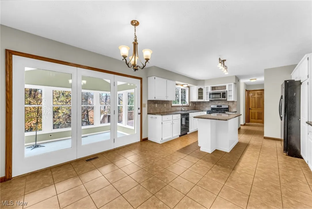View of Dining Niche in Kitchen. 4-Season Sunroom seen at left.
