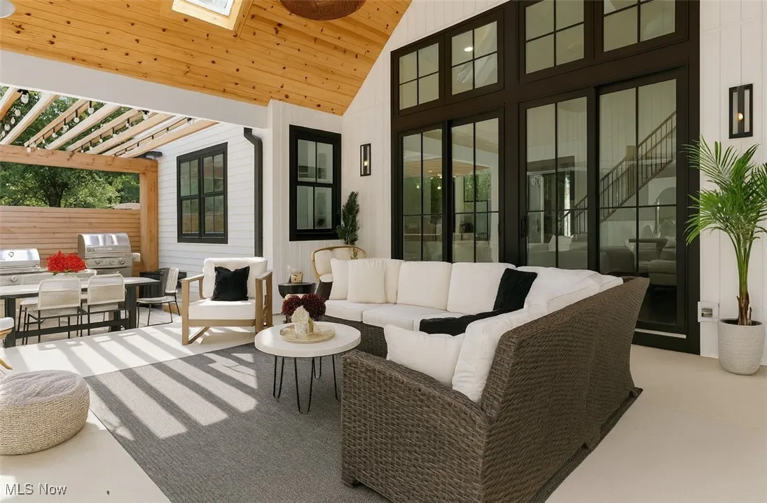 View of patio with a pergola, an outdoor hangout area, and exterior kitchen