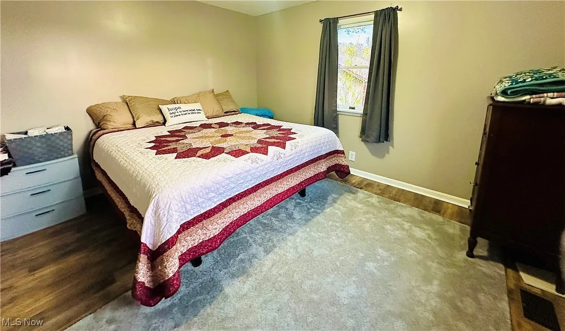 Bedroom featuring light wood-type flooring and baseboards