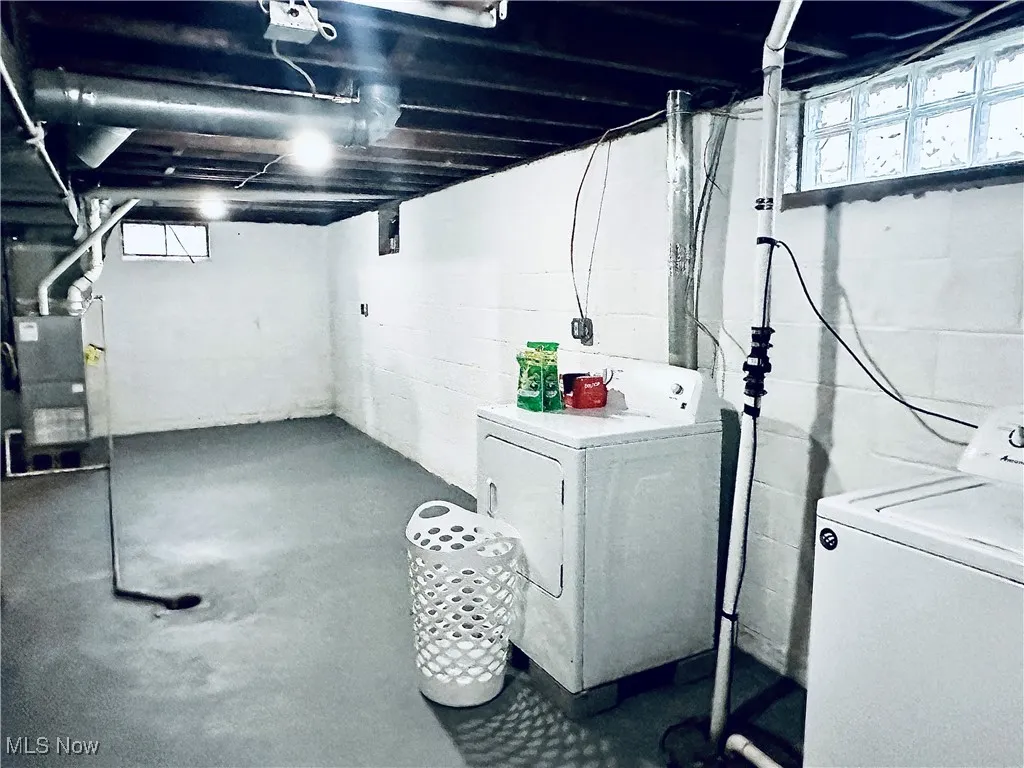 Basement with washing machine and dryer and heating unit