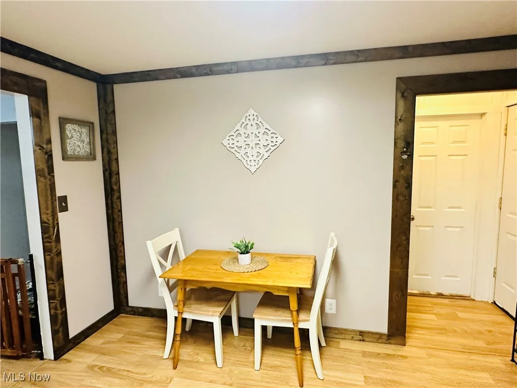 Dining area with light wood-style floors