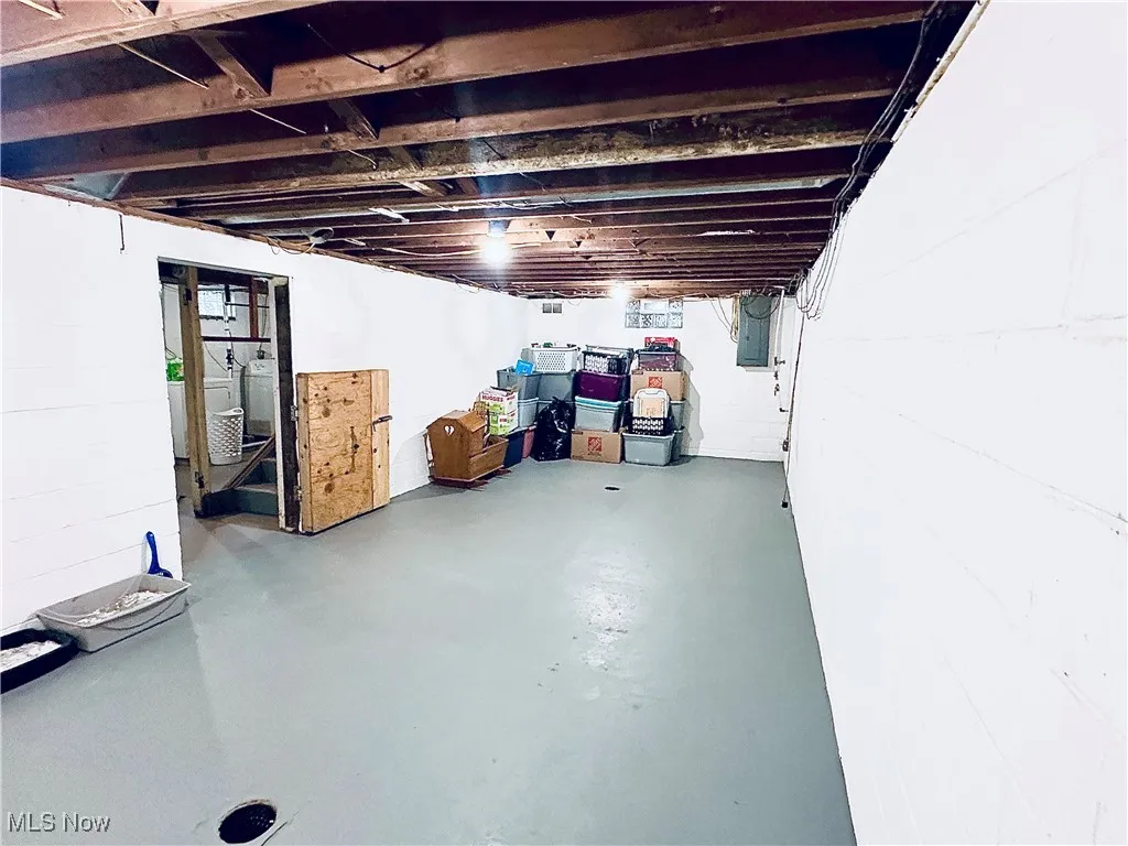 Unfinished basement featuring electric panel