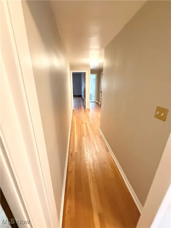 Corridor with light wood finished floors