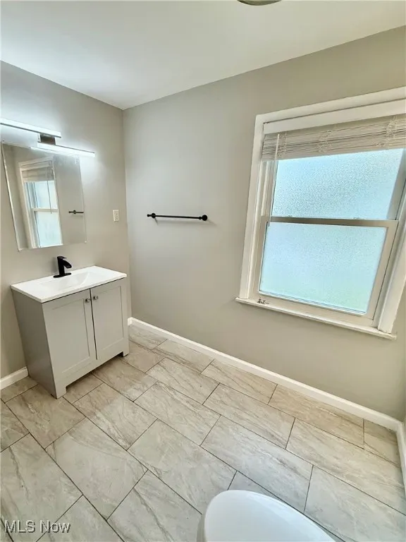 Bathroom with vanity and baseboards