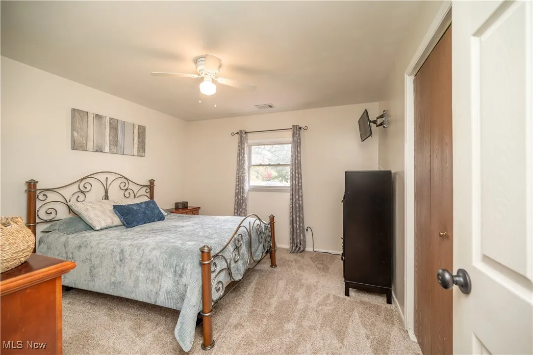 Primary bedroom with brand new carpet and closet for storage