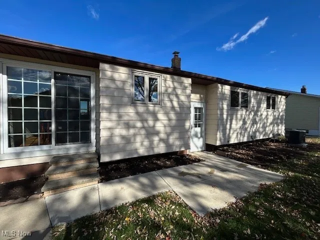 Back of property with a chimney