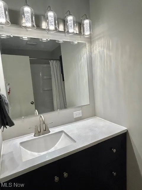 Bathroom with vanity and curtained shower