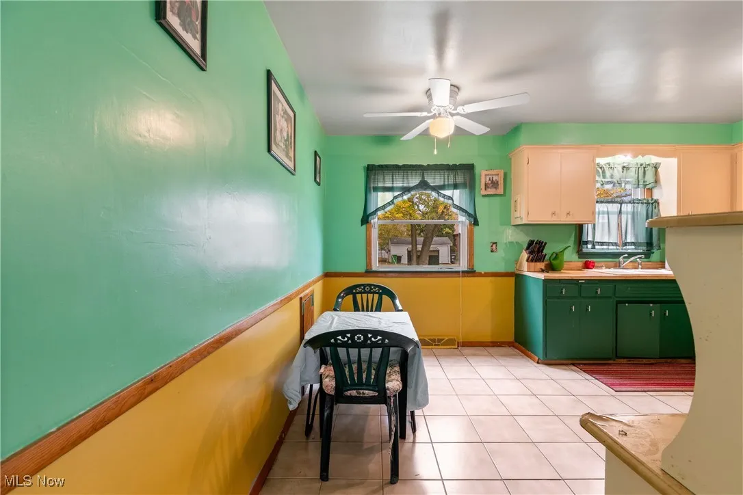 Kitchen featuring light countertops, light tile patterned flooring, and ceiling fan