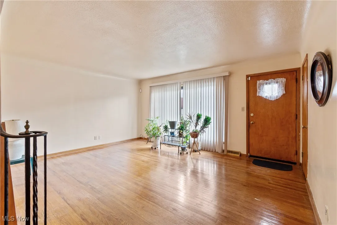 Entryway featuring a textured ceiling and wood-type flooring