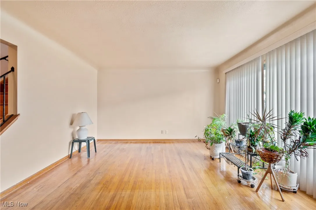 Unfurnished room with light wood-type flooring and a textured ceiling