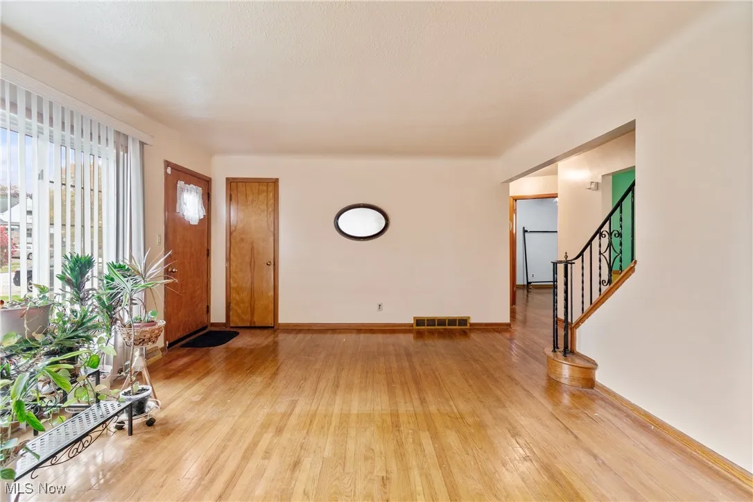 Entrance foyer with stairway and light wood-type flooring