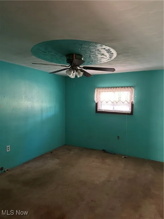 Bedroom with a ceiling fan and  carpet