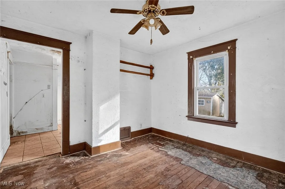 Spare room with hardwood / wood-style flooring and a ceiling fan