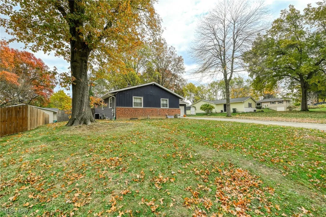 View of front of home with brick siding and board and batten siding