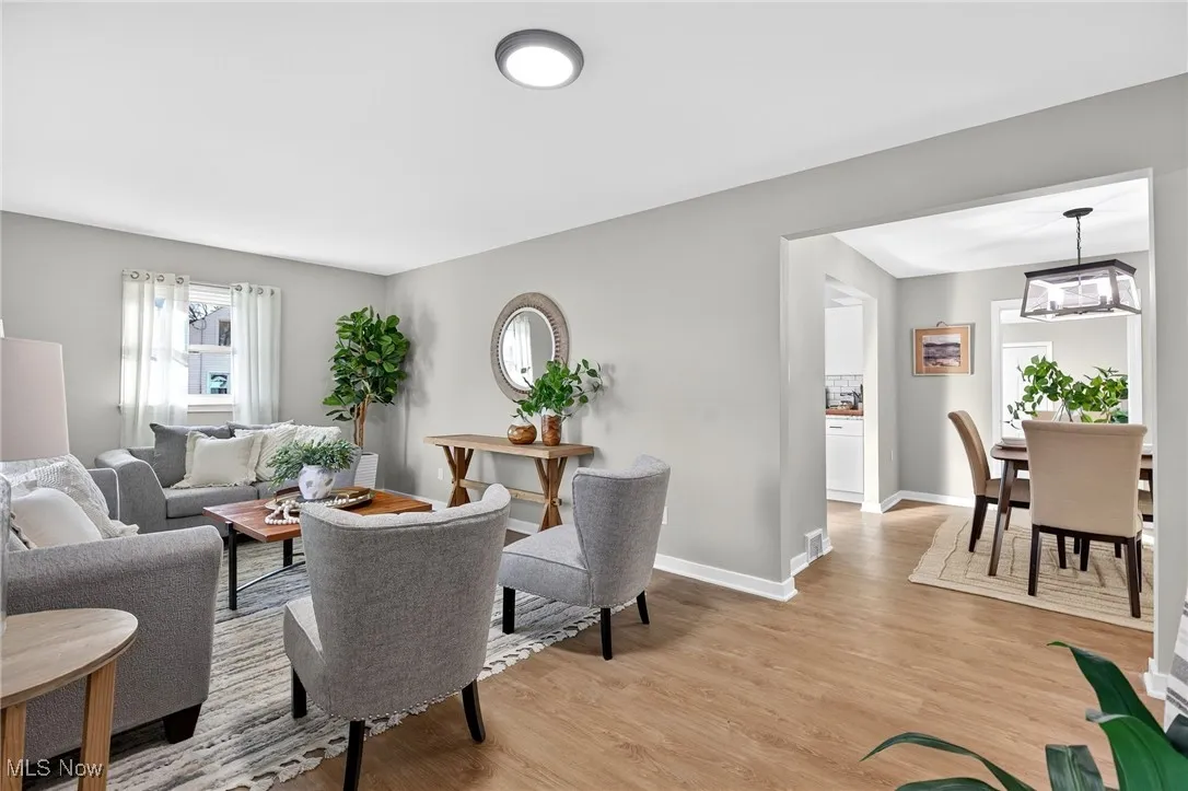 Living area with light wood-style floors and baseboards