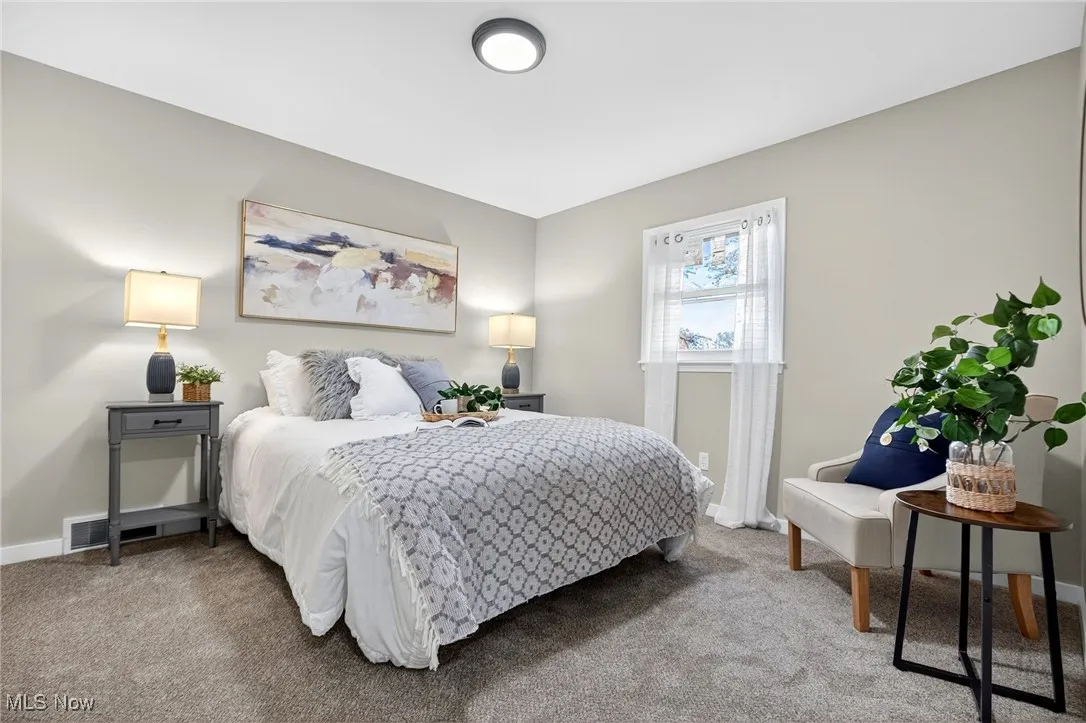 Carpeted bedroom featuring baseboards