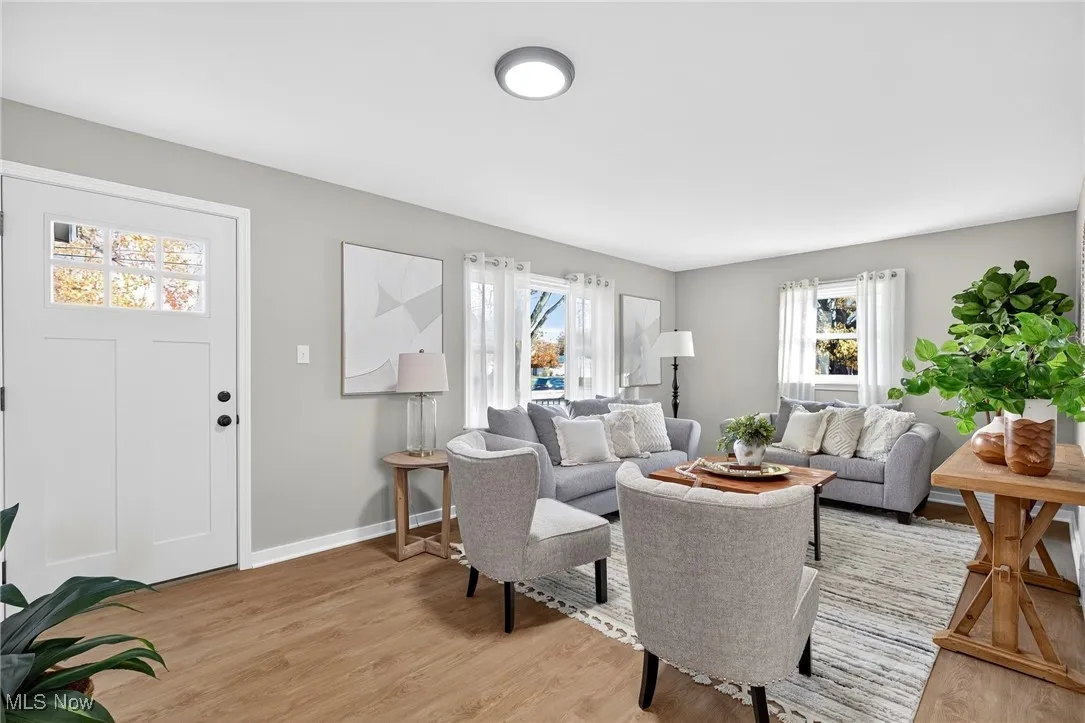 Living room featuring light wood-type flooring and baseboards