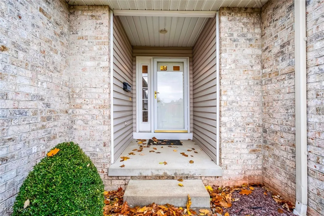 Entrance to property with brick siding