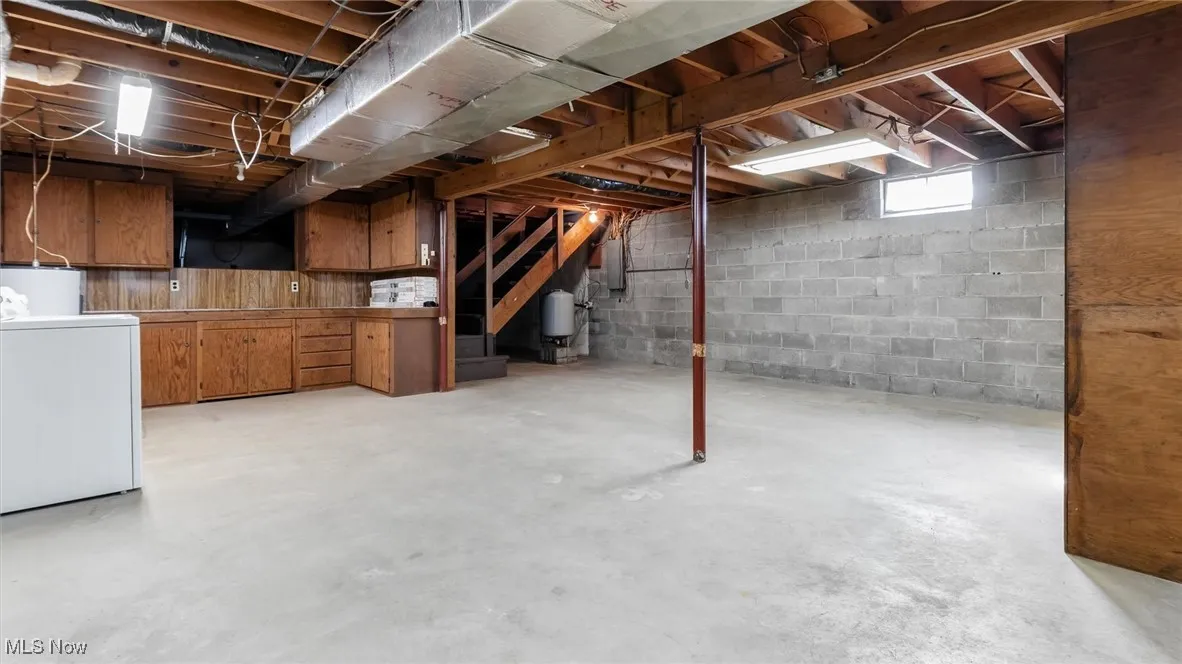 Basement featuring washer / dryer and stairs