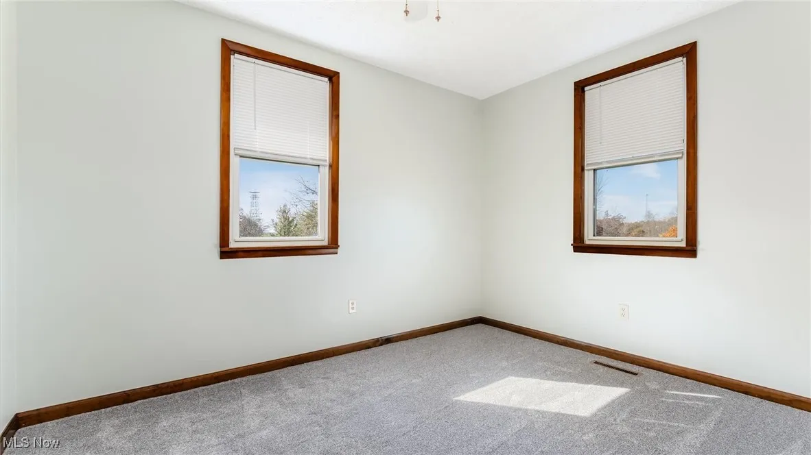Carpeted empty room with plenty of natural light