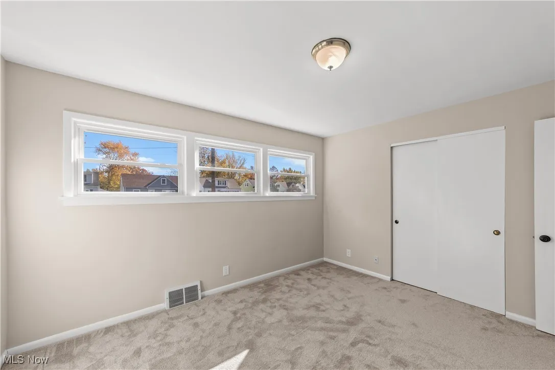 Unfurnished bedroom featuring carpet flooring and a closet
