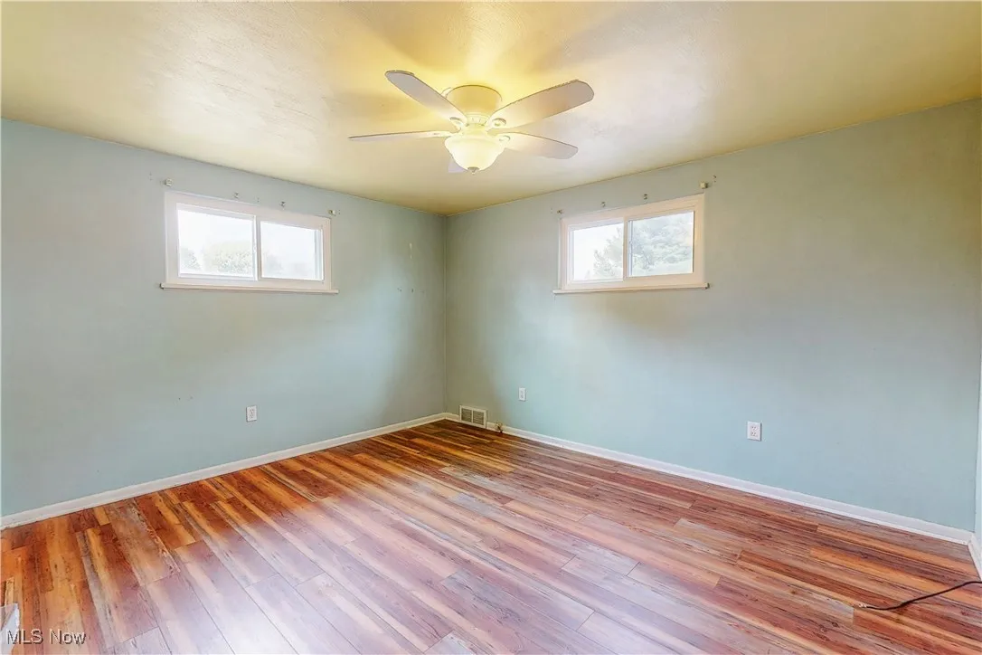 Unfurnished room featuring light wood-type flooring and ceiling fan