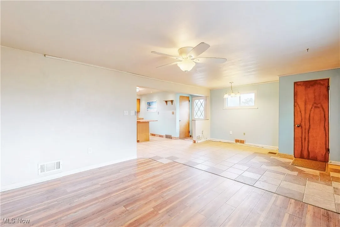 Unfurnished room featuring light wood finished floors and ceiling fan