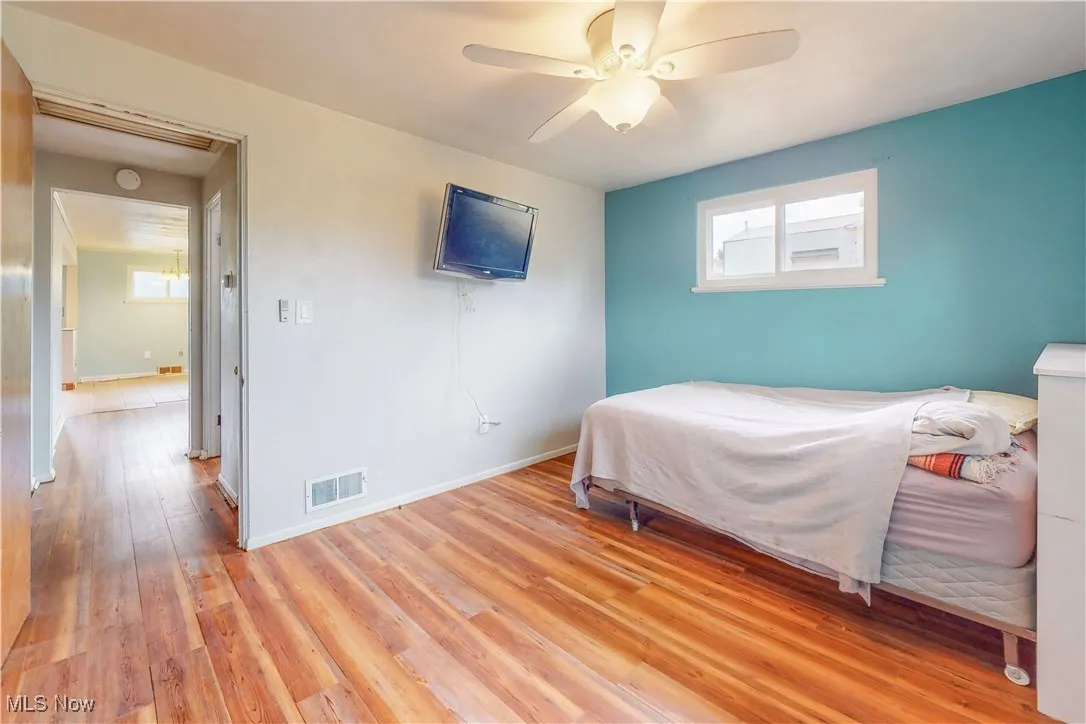 Bedroom with light wood finished floors and ceiling fan