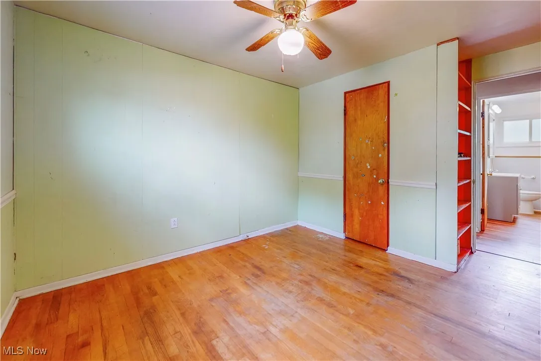 Unfurnished bedroom featuring hardwood / wood-style floors and a ceiling fan