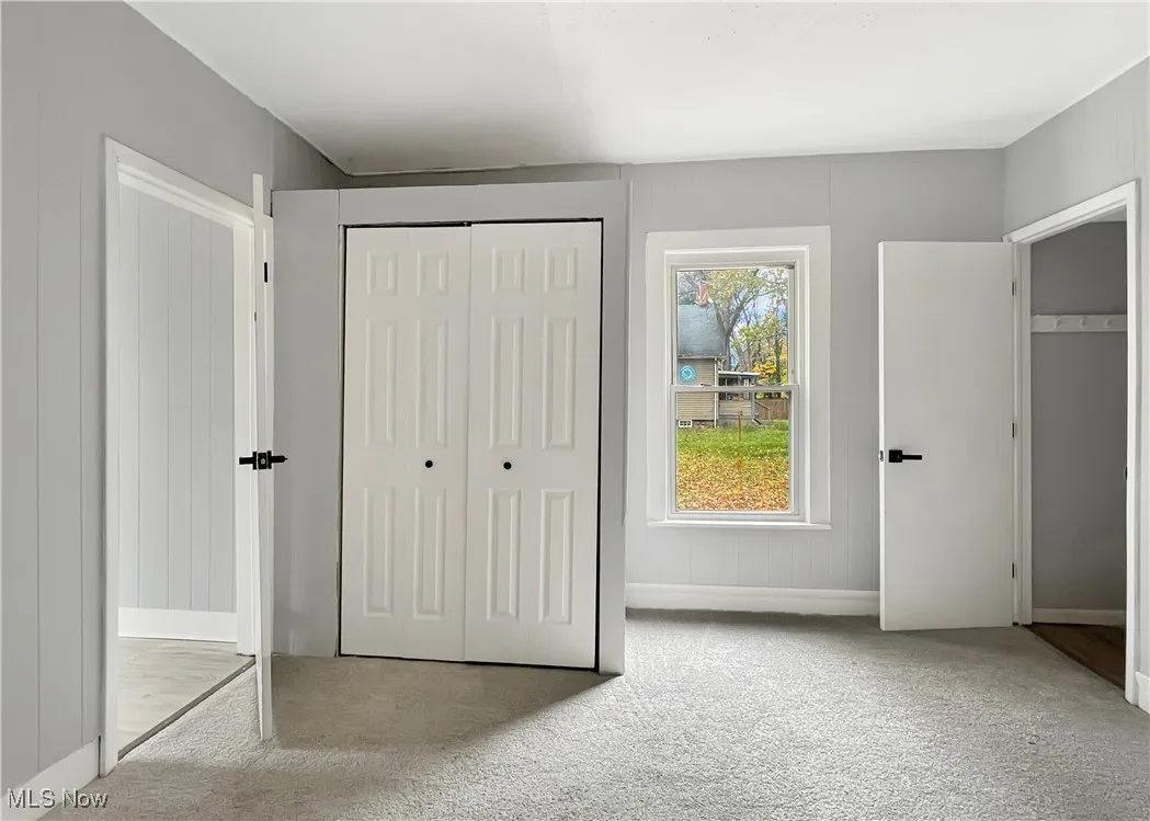 Unfurnished bedroom featuring carpet flooring and a closet