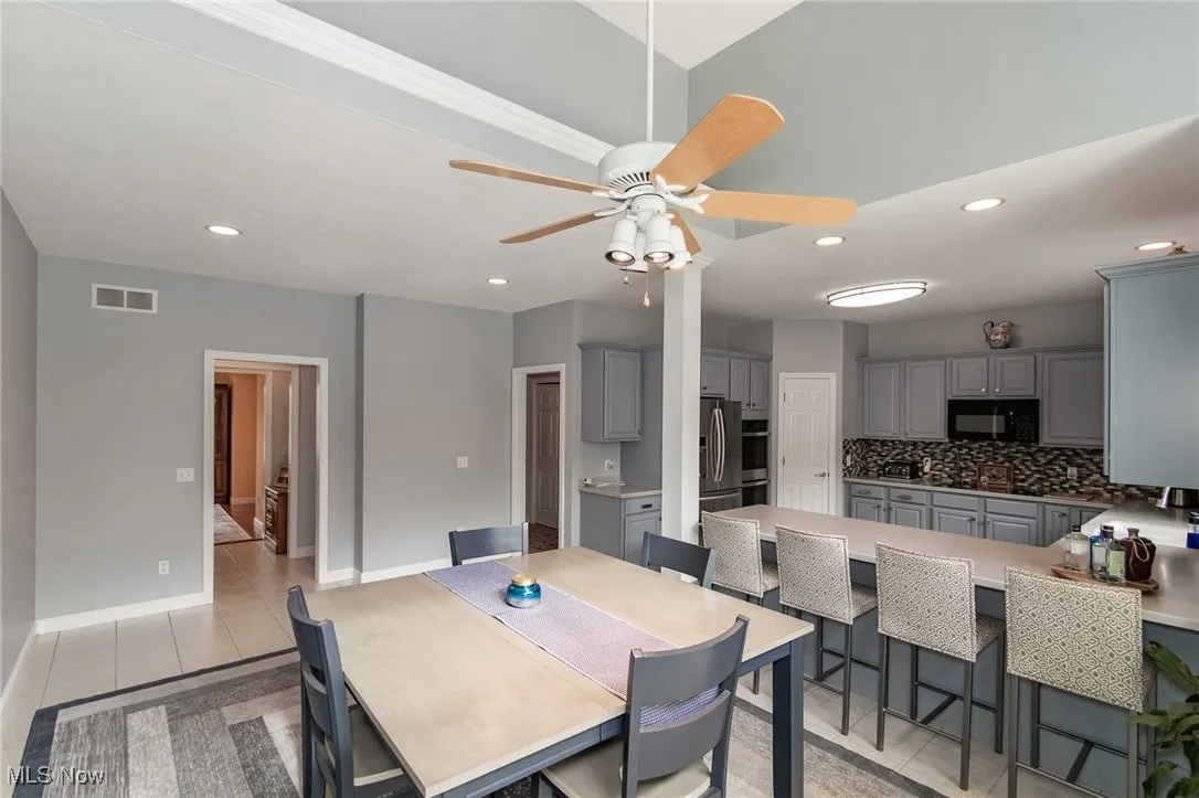 Dining room featuring light tile patterned floors, recessed lighting, and a ceiling fan