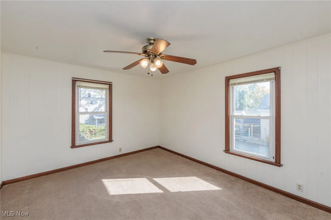 Carpeted bedroom with ceiling fan, fresh natural paint!