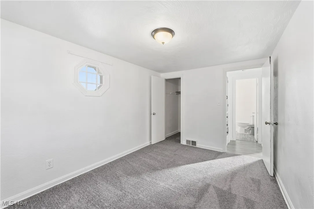 Unfurnished bedroom with carpet flooring and a closet