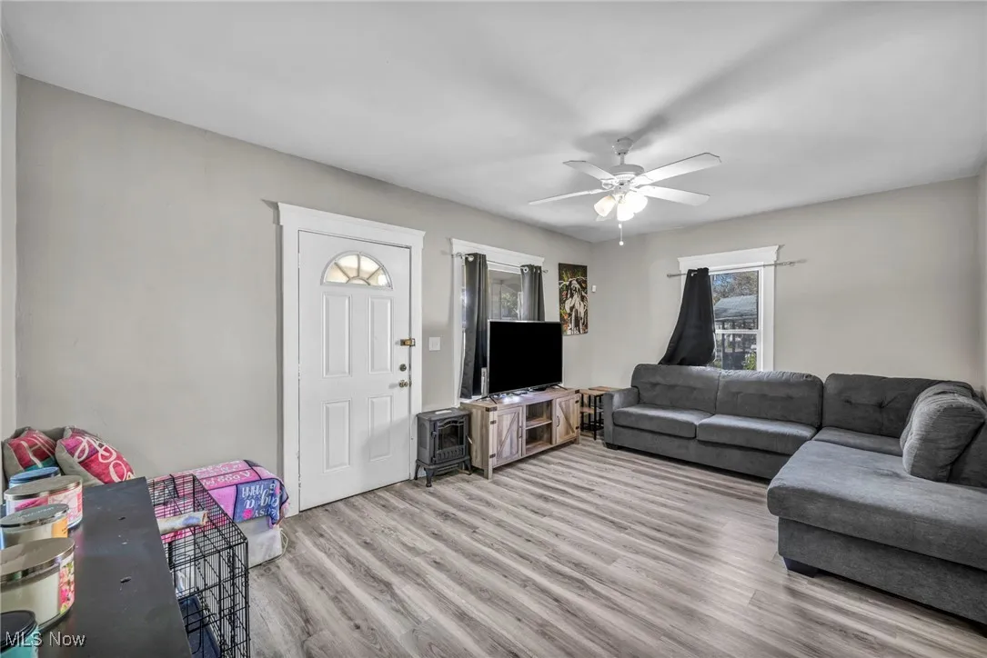 Living area featuring light wood-style floors and ceiling fan