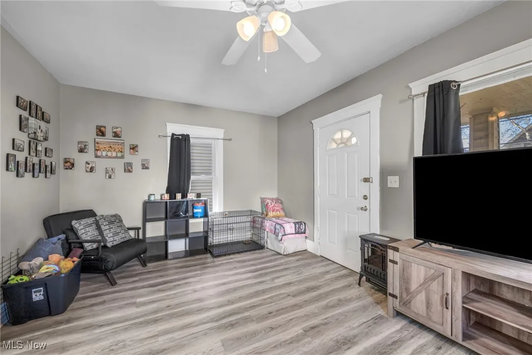 Living area featuring light wood-style flooring and ceiling fan