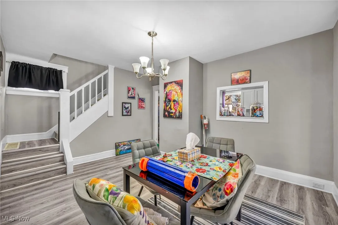 Dining area featuring stairs, a chandelier, and light wood finished floors
